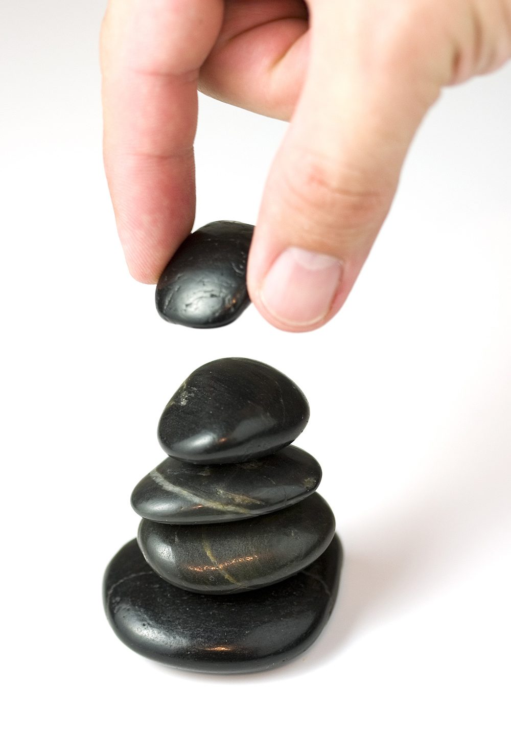 An image of someone stacking stones